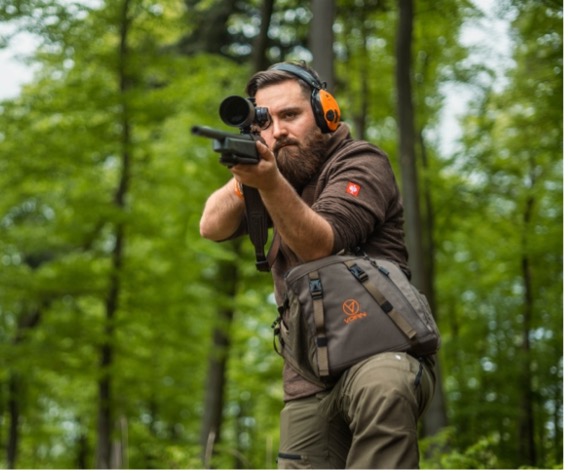 Hunter aiming a scoped rifle with a Vorn SR10 hip pack worn on the belt